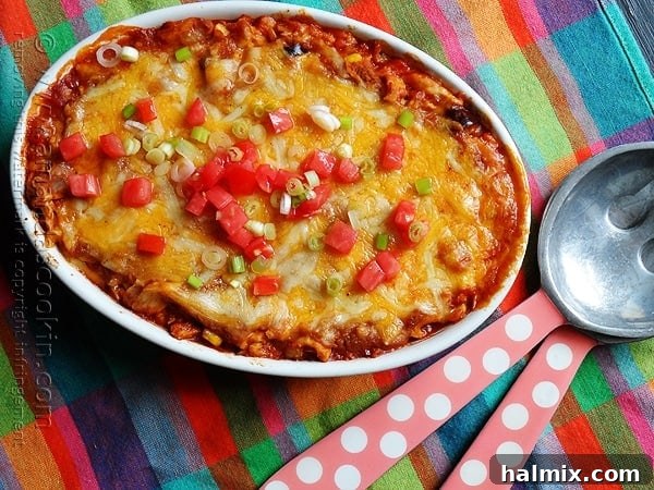 Delicious Chicken Tostada Casserole with vibrant green onions and diced tomatoes, ready to be served.