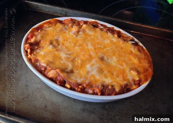 The final layer of shredded cheese on the Chicken Tostada Casserole before baking.