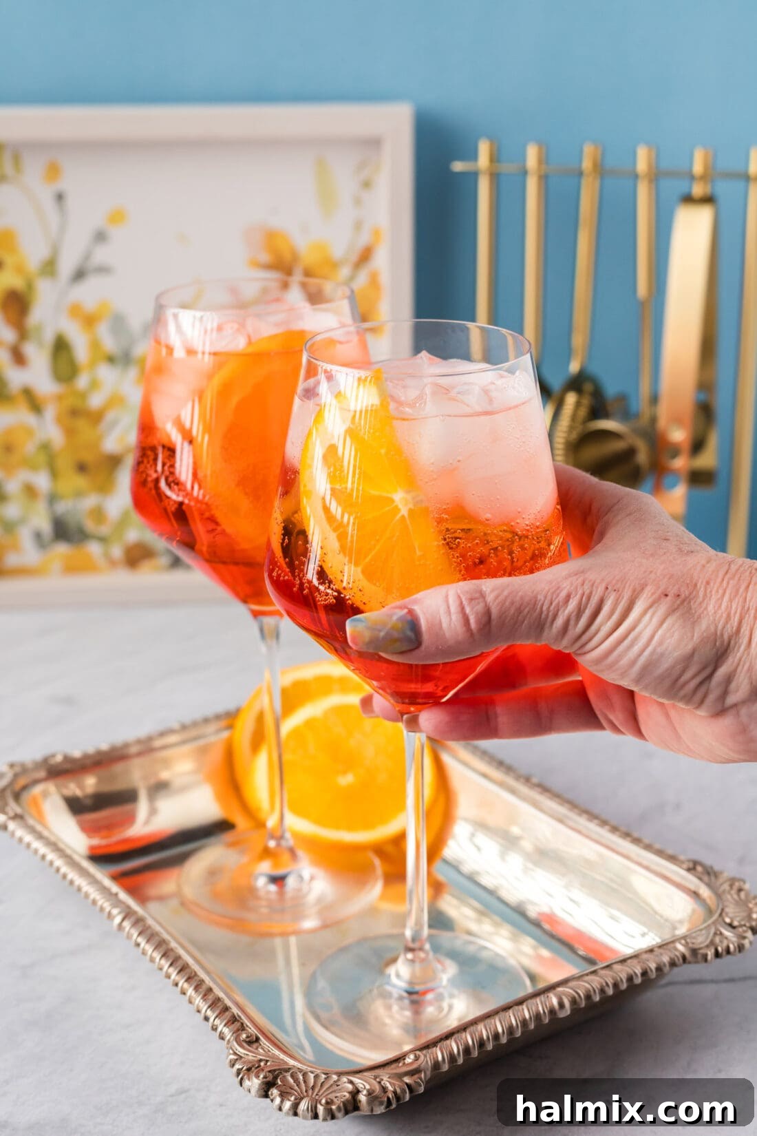 Hand grabbing a Aperol Spritz