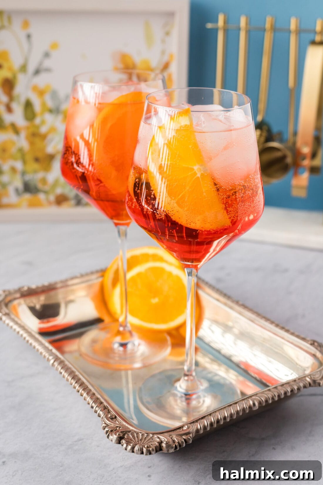 Two Aperol Spritz cocktails on a serving platter