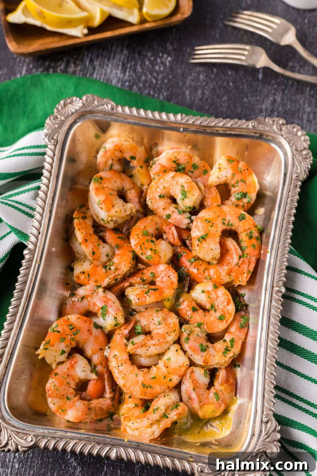 Garlic Butter Baked Shrimp 2 Buttery baked shrimp beautifully arranged in a serving platter, garnished with fresh herbs.