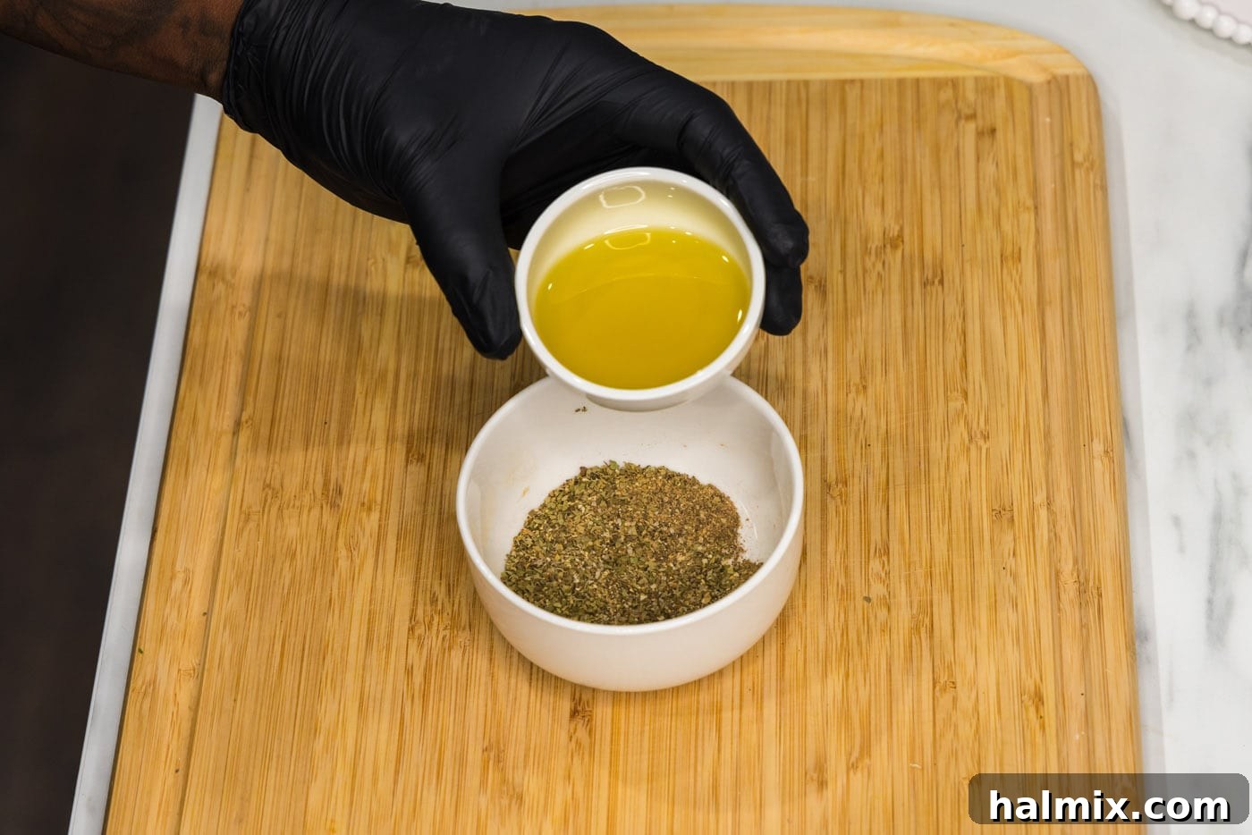 Crispy Instant Pot Carnitas 6 adding olive oil to seasonings in a bowl