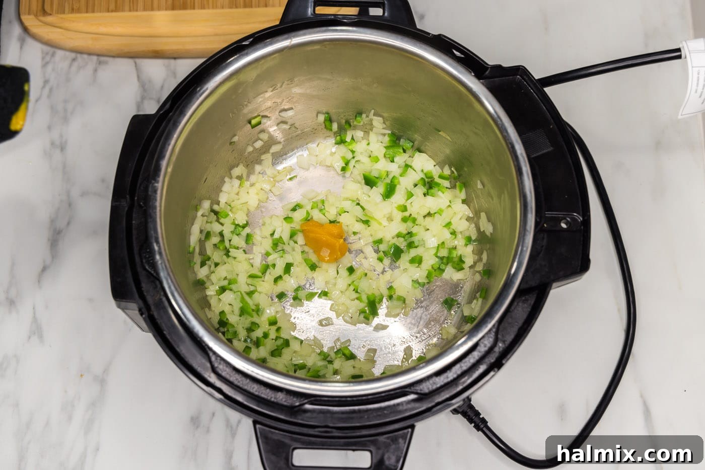 Crispy Instant Pot Carnitas 9 adding beef base to satueed vegetables in an instant pot