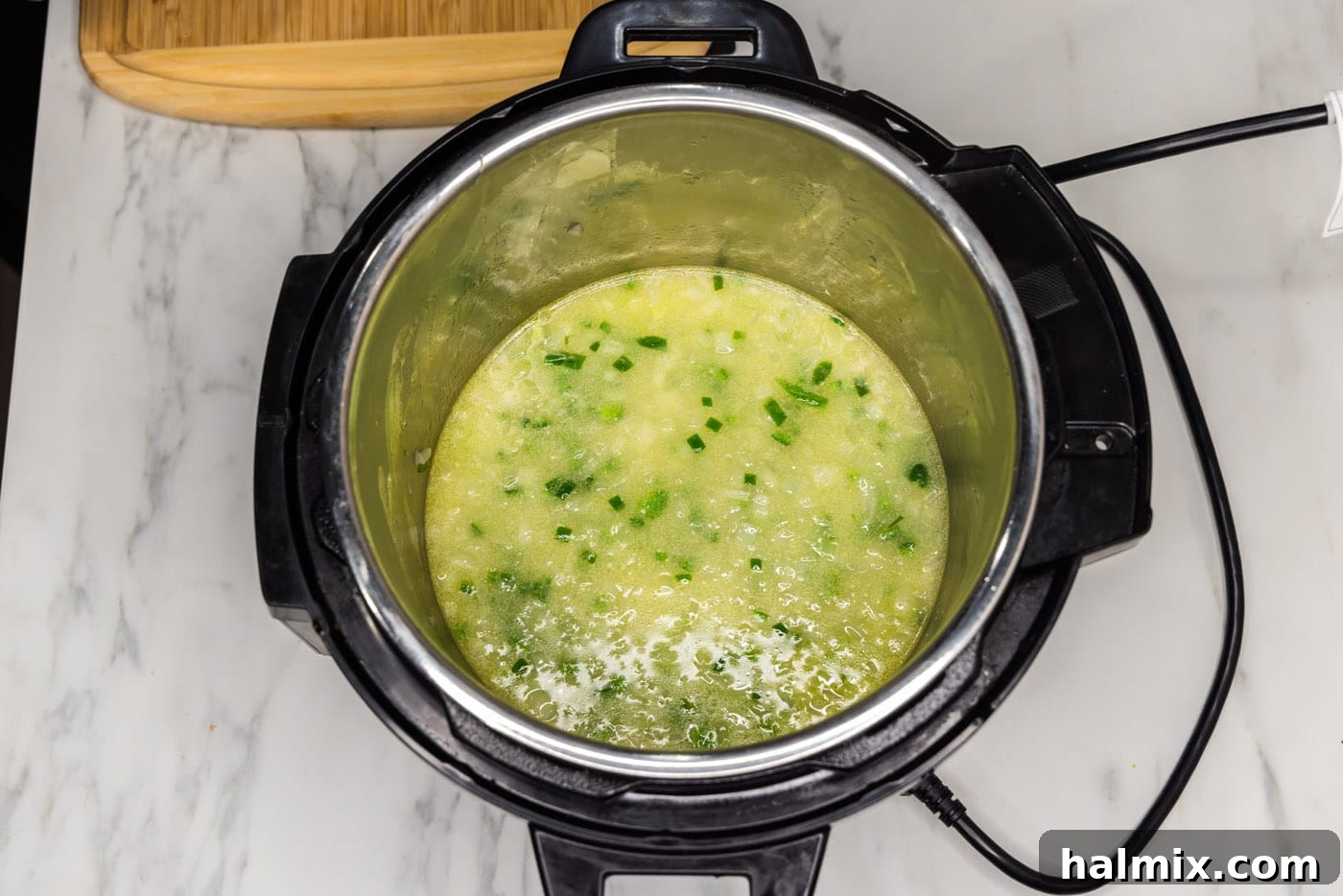 Crispy Instant Pot Carnitas 10 water, chicken base, and vegetables in pressure cooker
