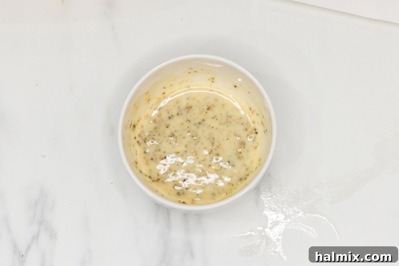 Melted butter and seasoning mixture in a small bowl.
