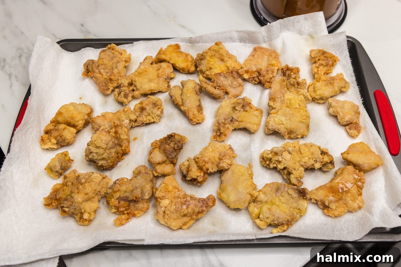 crispy coated chicken pieces on a paper towel