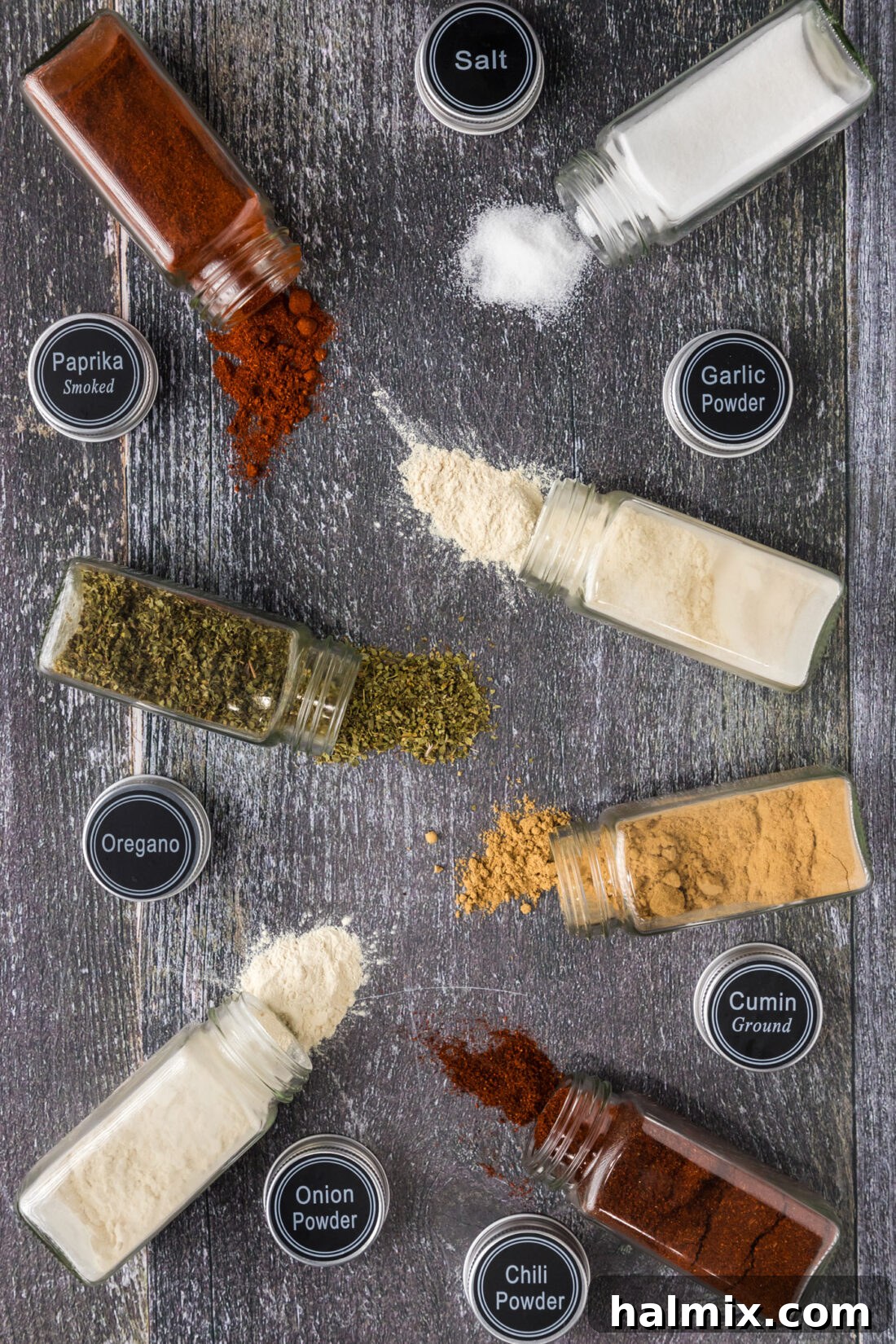 Spices jars needed for Mexican Seasoning spilled on a table