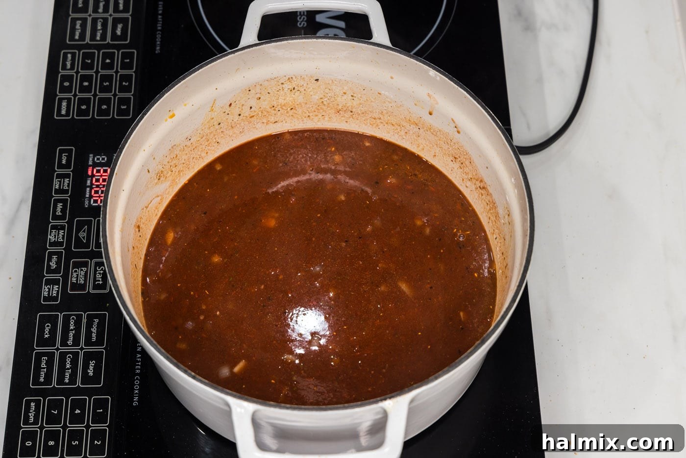 The braising liquid, a rich and aromatic mixture, is shown simmering in a Dutch oven.