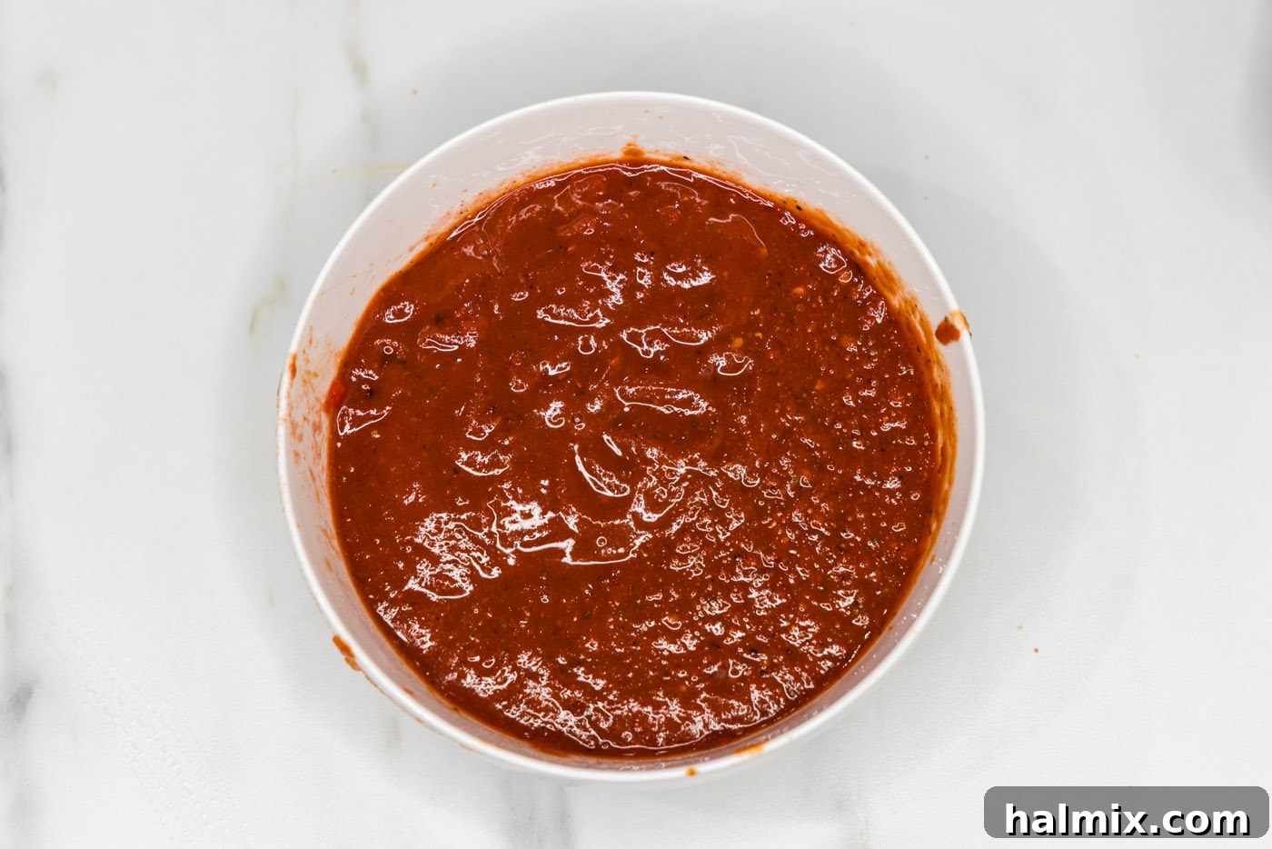 The blended chipotle sauce is shown in a bowl, smooth and ready to be incorporated into the braising liquid.
