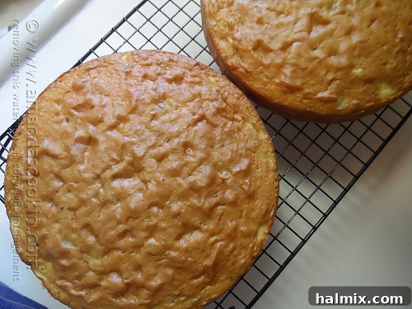 Two golden-brown Merryfield apple cakes cooling on a wire rack, filling the kitchen with a sweet, inviting aroma.