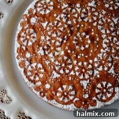 A overhead photo of a Merryfield apple cake on a decorative white platter.