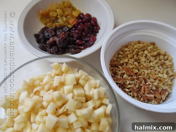 All the wholesome additions for the Merryfield Apple Cake – chopped apples, nuts, and various raisins – gathered in a single bowl.
