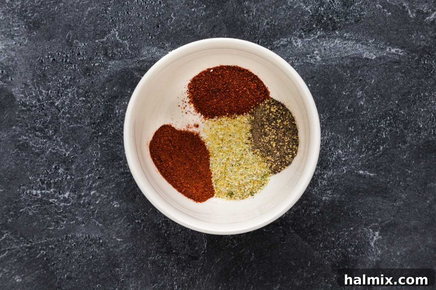 The Smoked Salmon Experience 6 A bowl containing a mix of chili powder, paprika, garlic salt, and black pepper