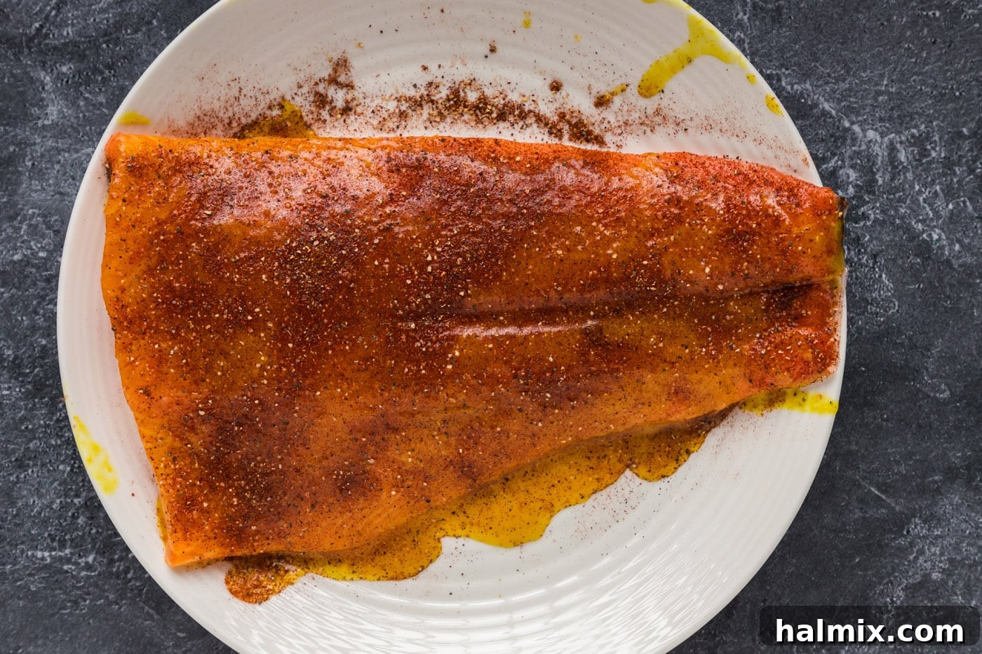 A salmon fillet seasoned with the dry rub, ready for the smoker