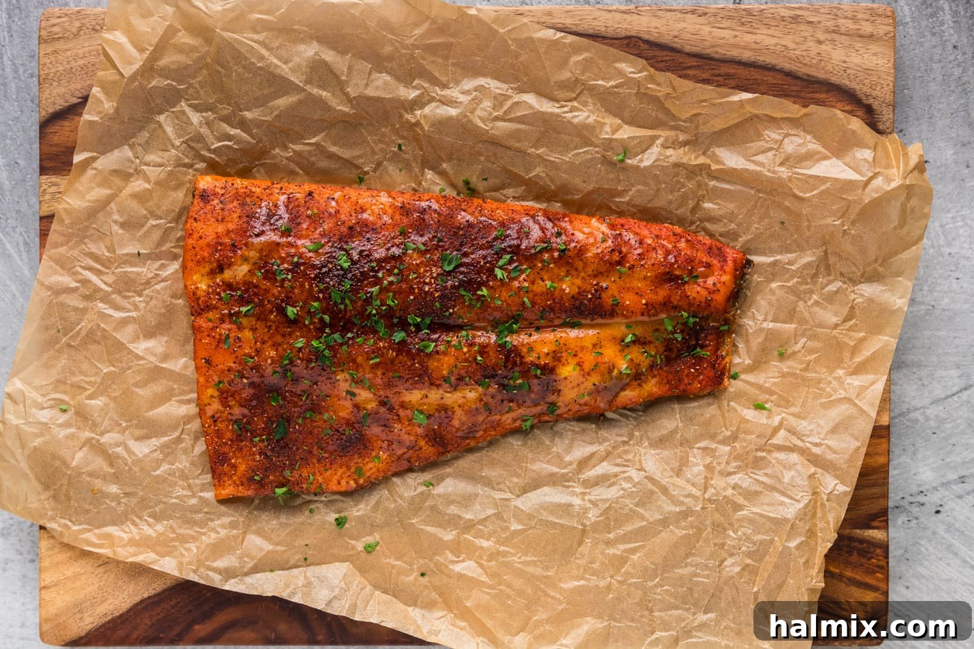 Easy smoked salmon recipe presented on parchment paper on a cutting board, ready to serve