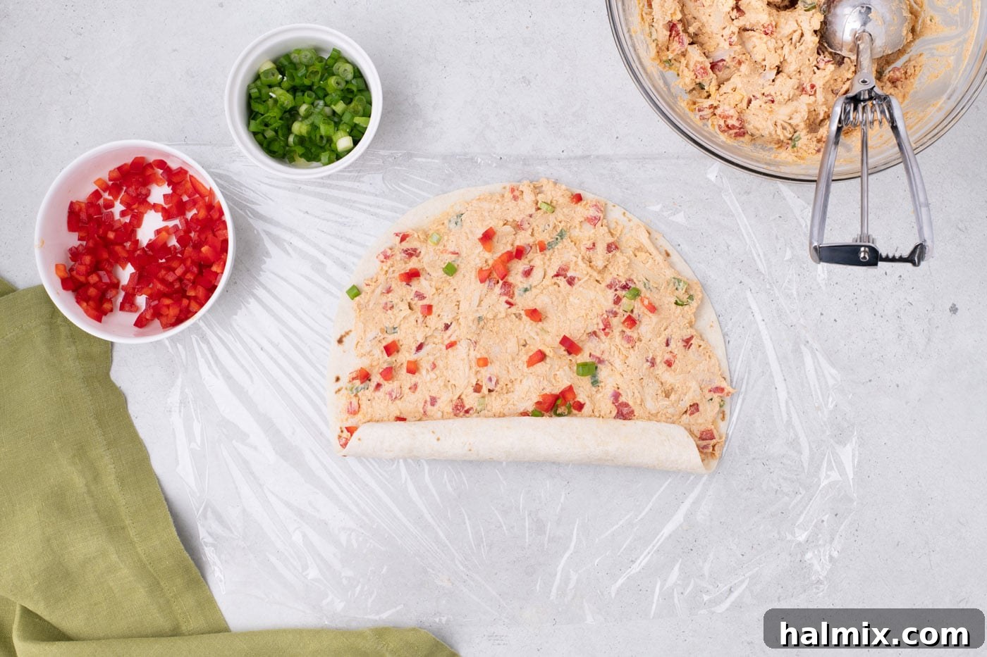 rolling burrito wrap up with cream cheese and chicken mixture