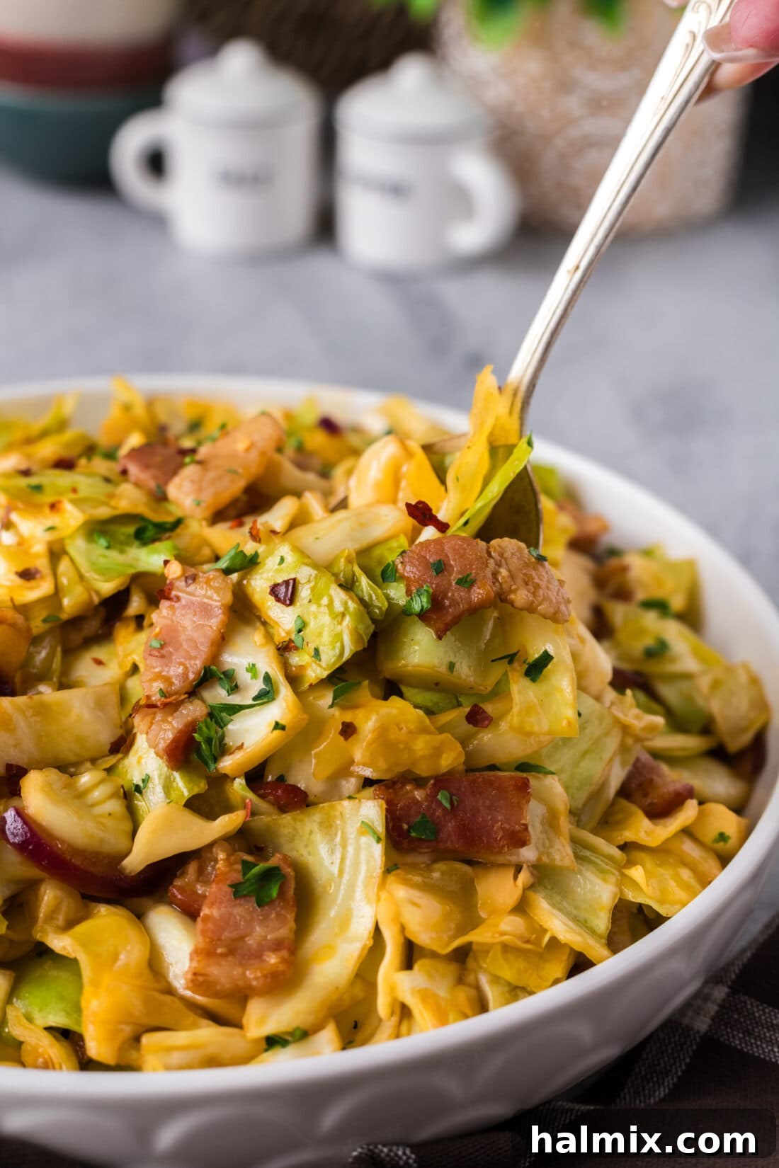 Fiery Fried Cabbage 2 Spoon in a bowl of Spicy Fried Cabbage
