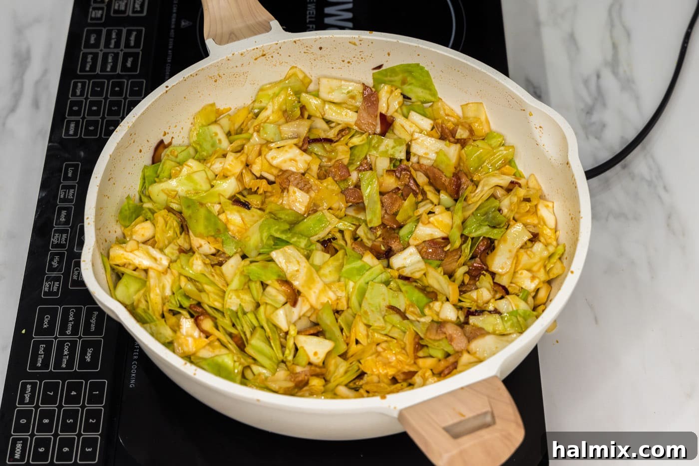 Fiery Fried Cabbage 10 spicy fried cabbage in a skillet with seasonigs