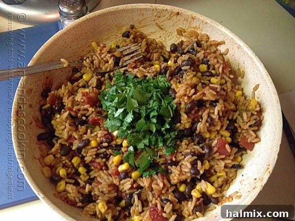 A bowl of Spanish rice, black beans, corn, and fresh cilantro, beautifully tossed and ready to be served.
