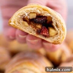 Apple Pie Bite cut in half, showing the warm apple filling inside the flaky crust.
