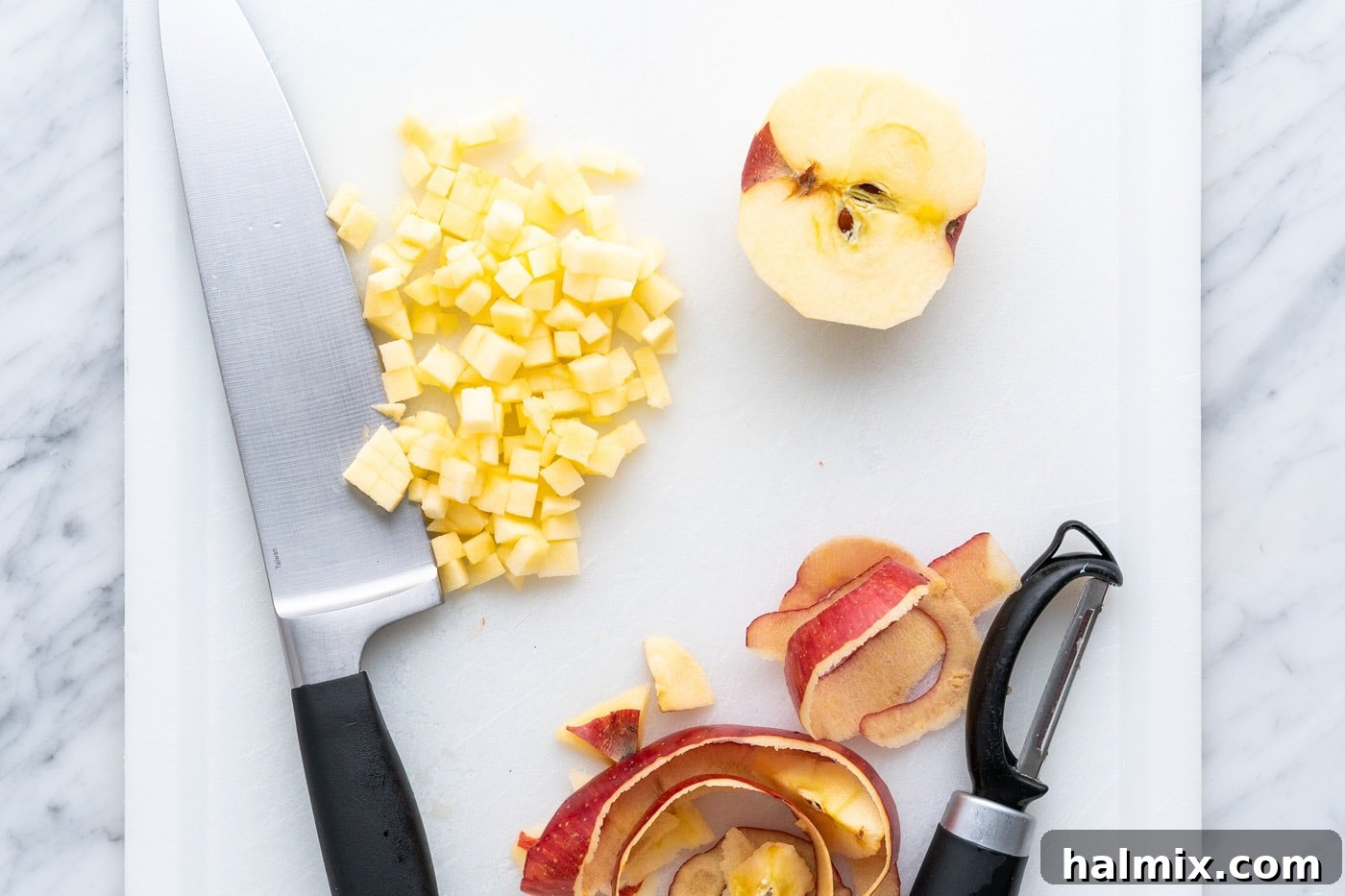 A bowl of freshly peeled and diced apples, ready for the filling.