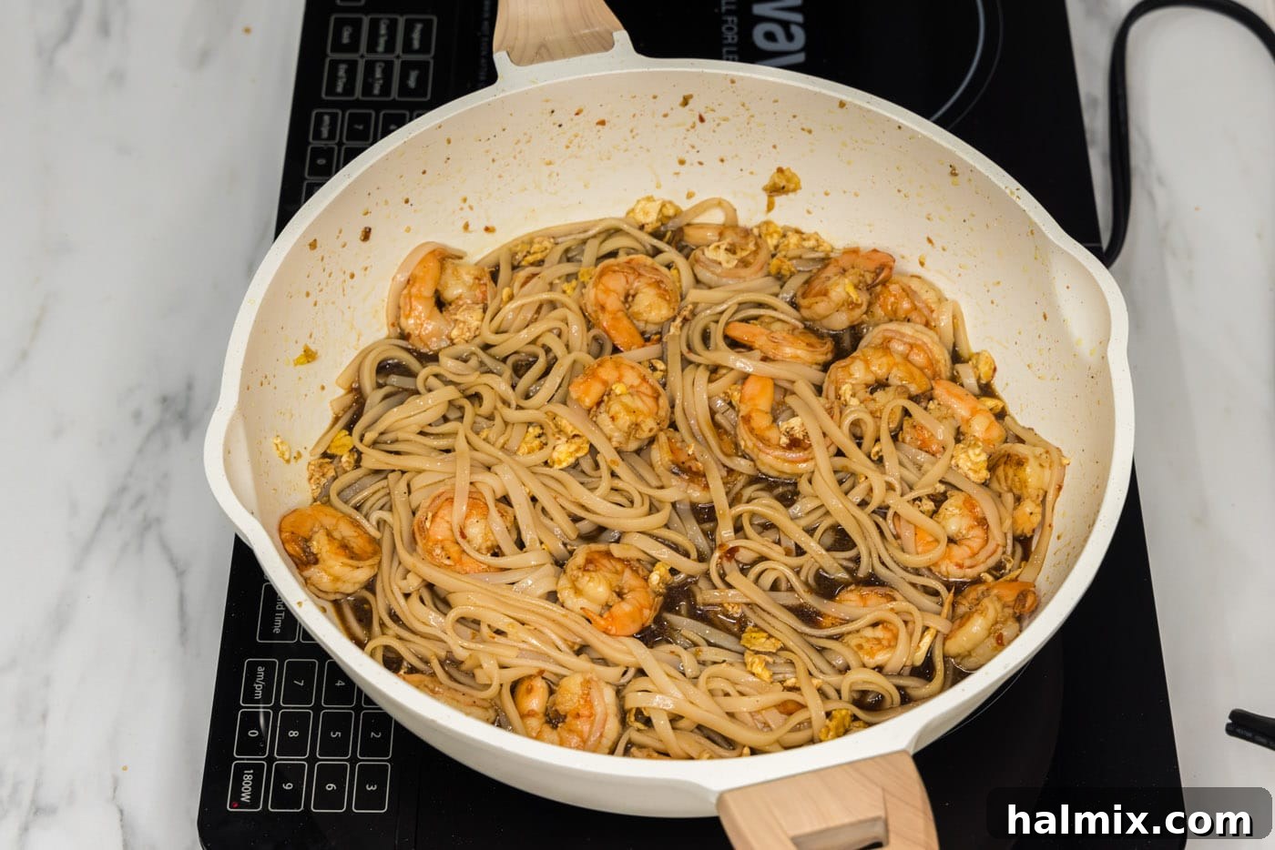 The finished easy Shrimp Pad Thai dish, simmering gently in a large skillet.