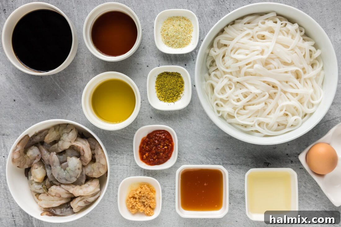 Vibrant Shrimp Pad Thai 4 A collection of fresh ingredients laid out on a wooden board, including shrimp, rice noodles, various sauces, and aromatics, for making Shrimp Pad Thai.