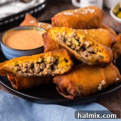 Big Mac Egg Roll cut in half resting on other Big Mac Egg Rolls