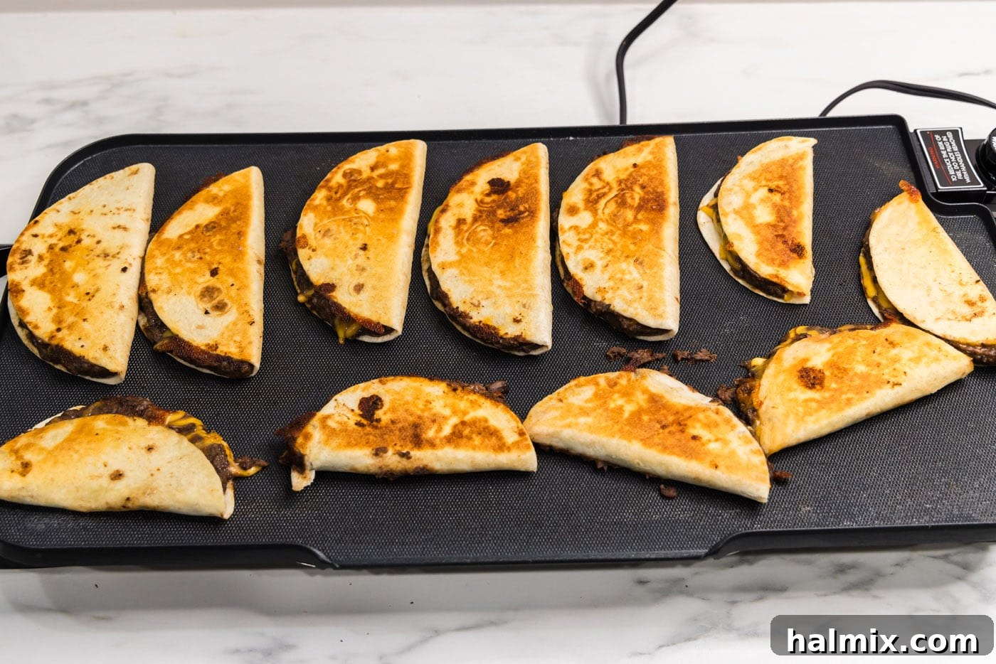 cooked black bean tacos on a griddle