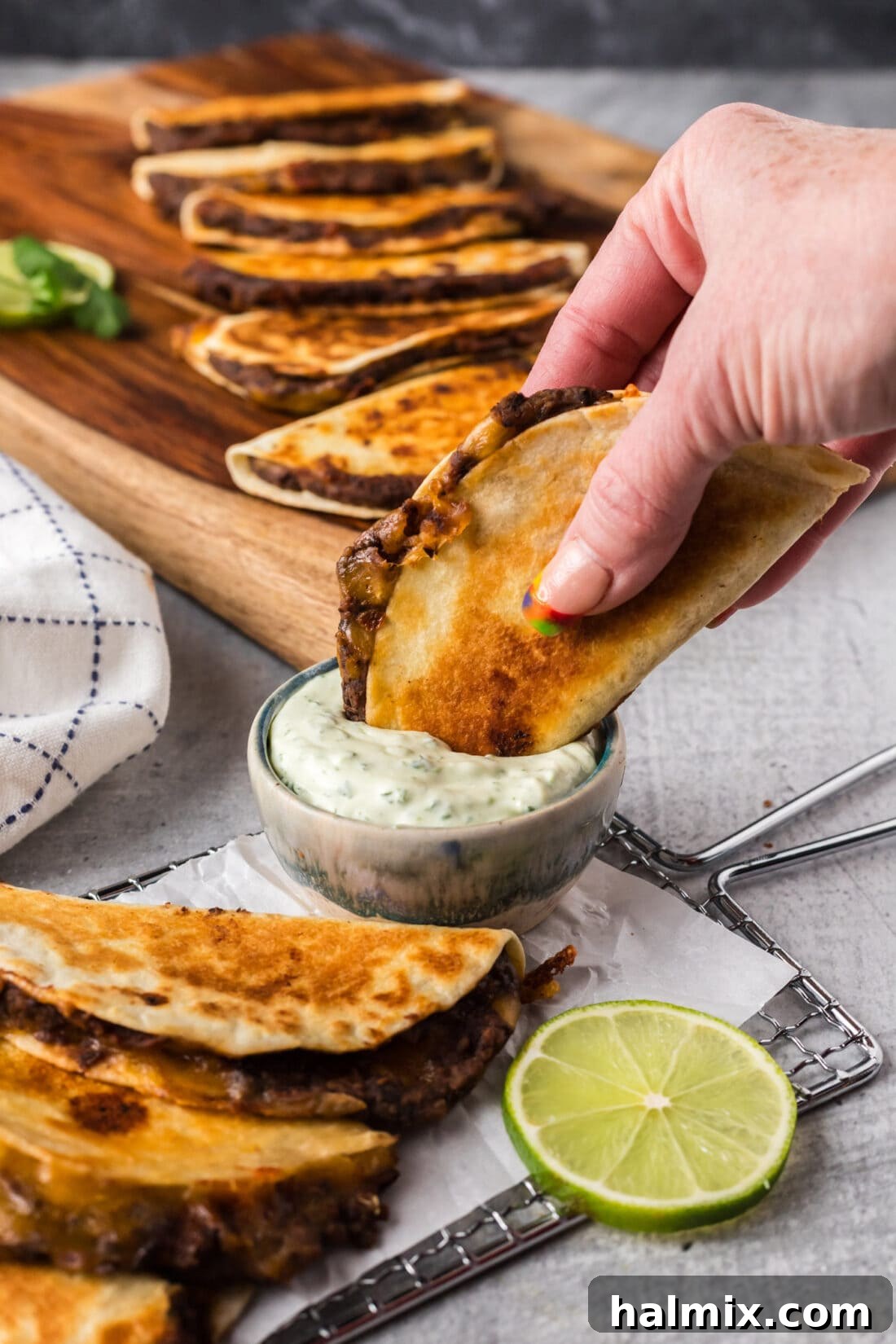Black Bean Taco being dipped into a bowl of sauce