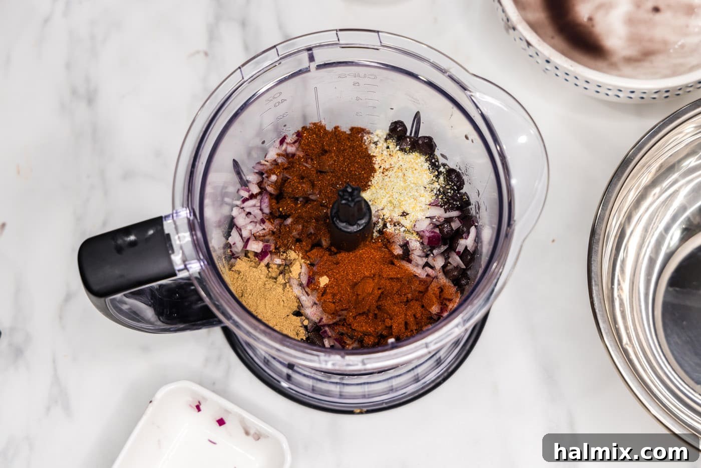 black beans with spices and seasonings in a food chopper